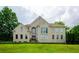 Brick two-story house with a large front yard and mature trees at 2120 Shaffer Rd, Cumming, GA 30041