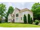 Tan brick house with a landscaped yard and lush greenery at 2120 Shaffer Rd, Cumming, GA 30041