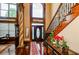 Grand foyer with hardwood floors, a sweeping staircase, and ornate columns at 2120 Shaffer Rd, Cumming, GA 30041