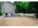 Large side yard with gravel parking area and retaining walls at 2120 Shaffer Rd, Cumming, GA 30041