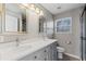 Modern bathroom featuring double vanity, quartz countertop, updated fixtures, and decorative mirrors at 2409 Swallow Se Cir, Atlanta, GA 30315