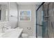 Bathroom featuring modern sink and faucet, tiled shower with frameless glass door, and neutral paint at 2409 Swallow Se Cir, Atlanta, GA 30315