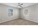 Carpeted bedroom with modern ceiling fan and natural light from two windows at 2409 Swallow Se Cir, Atlanta, GA 30315
