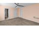 Peach bedroom with carpeted floors, natural light from windows, and a ceiling fan at 2409 Swallow Se Cir, Atlanta, GA 30315
