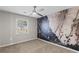 Cozy carpeted bedroom with modern fan and statement marble accent wall at 2409 Swallow Se Cir, Atlanta, GA 30315