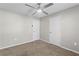Neutral bedroom featuring a ceiling fan, two white doors and carpet floors at 2409 Swallow Se Cir, Atlanta, GA 30315