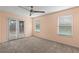 Peach bedroom with carpeted floors, natural light from windows, and a ceiling fan at 2409 Swallow Se Cir, Atlanta, GA 30315