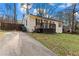 Exterior view of home with painted brick, a quaint porch, driveway, and partial fenced yard at 2409 Swallow Se Cir, Atlanta, GA 30315