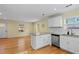 Open-concept kitchen featuring stainless steel appliances, a breakfast bar, and wood flooring at 2409 Swallow Se Cir, Atlanta, GA 30315