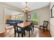 Inviting dining room featuring hardwood floors, stylish lighting, and seamless flow to the cozy living area at 6550 Bridgewood Valley Rd, Atlanta, GA 30328