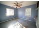 Blue bedroom with carpet, ceiling fan, and window at 1803 Fay Se St, Atlanta, GA 30316