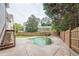 The backyard features a stone pool with hot tub, lush foliage, and stone paver surround at 1901 Shelburne Cv, Marietta, GA 30068