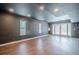 Finished basement featuring dark walls, wood floors, natural light and convenient walkout doors at 1901 Shelburne Cv, Marietta, GA 30068