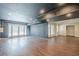 Finished basement showcasing dark and neutral color palette, wood floors, and walkout doors at 1901 Shelburne Cv, Marietta, GA 30068