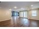 Spacious finished basement with neutral walls, wood floors, and walkout doors, ideal for a living space at 1901 Shelburne Cv, Marietta, GA 30068