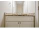 Bathroom with a granite countertop, neutral walls, and a large mirror at 1901 Shelburne Cv, Marietta, GA 30068