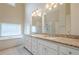 Bathroom featuring double vanity with granite counters, bath, and shower at 1901 Shelburne Cv, Marietta, GA 30068