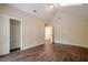 A large bedroom featuring hardwood floors, a closet, and an adjacent bathroom at 1901 Shelburne Cv, Marietta, GA 30068