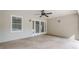 Covered patio featuring stone flooring, ceiling fan, and double doors to the main house at 1901 Shelburne Cv, Marietta, GA 30068