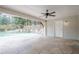 Inviting covered patio featuring stone flooring, ceiling fan, and access to the pool at 1901 Shelburne Cv, Marietta, GA 30068