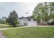Beautiful home featuring a manicured lawn, mature trees and a three-car garage, creating an inviting curb appeal at 1901 Shelburne Cv, Marietta, GA 30068