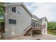 Rear exterior elevation of home featuring an upper deck, lower patio, and access stairs at 1901 Shelburne Cv, Marietta, GA 30068