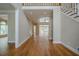 Spacious foyer with hardwood floors, staircase and view into rooms with large windows and natural light at 1901 Shelburne Cv, Marietta, GA 30068