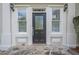 Elegant front door with decorative glass, flanked by sidelight windows and classic sconces at 1901 Shelburne Cv, Marietta, GA 30068
