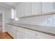 Kitchen features custom white cabinetry, granite counters, subway tile backsplash and hardwood floors at 1901 Shelburne Cv, Marietta, GA 30068