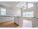 Sun-filled kitchen featuring granite countertops, white cabinetry, and an island cooktop at 1901 Shelburne Cv, Marietta, GA 30068