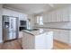 Modern kitchen features an island cooktop, stainless steel appliances, and bright, white cabinetry at 1901 Shelburne Cv, Marietta, GA 30068