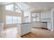 Sun-filled kitchen featuring granite countertops, white cabinetry, island cooktop, and hardwood flooring at 1901 Shelburne Cv, Marietta, GA 30068