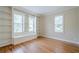 Bright living room featuring hardwood floors and built-in shelves at 1901 Shelburne Cv, Marietta, GA 30068