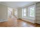 Bright living room with hardwood floors, built-in shelves, and staircase at 1901 Shelburne Cv, Marietta, GA 30068