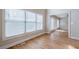 Bright living area features large windows, hardwood flooring and access to other rooms at 1901 Shelburne Cv, Marietta, GA 30068