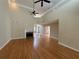 Living room featuring hardwood floors, fireplace, and view into sun room at 1901 Shelburne Cv, Marietta, GA 30068