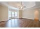 Large main bedroom with tray ceiling, fan, and luxury vinyl flooring at 1901 Shelburne Cv, Marietta, GA 30068