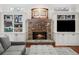 Stone fireplace with built-in shelving on either side at 2012 Mendenhall Cir, Atlanta, GA 30341