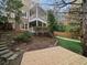 Brick house with a screened porch, pergola, and stairs leading to the backyard at 2012 Mendenhall Cir, Atlanta, GA 30341