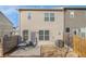 Backyard with a gray two story house and a patio surrounded by a wooden fence at 366 Cherryhill Ln, Woodstock, GA 30188