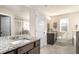 Clean bathroom with double vanity, granite countertops, a separate tub, and a glass shower at 366 Cherryhill Ln, Woodstock, GA 30188