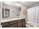 Bathroom with a dual sink vanity, large mirror and shower curtain at 366 Cherryhill Ln, Woodstock, GA 30188