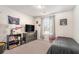 Carpeted bedroom features neutral walls, a window, and is decorated with sports memorabilia at 366 Cherryhill Ln, Woodstock, GA 30188