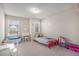 Bright bedroom with neutral walls, two windows, and a vanity and play area at 366 Cherryhill Ln, Woodstock, GA 30188