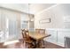 Cozy dining area with natural light, a modern chandelier, and access to the backyard at 366 Cherryhill Ln, Woodstock, GA 30188