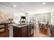 Bright, open kitchen with granite countertops and a breakfast bar overlooking the living area at 366 Cherryhill Ln, Woodstock, GA 30188