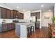 Well-lit kitchen with stainless steel appliances, a large island, and dark wood cabinets at 366 Cherryhill Ln, Woodstock, GA 30188