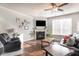 Cozy living room with fireplace, plush seating, and plenty of natural light at 366 Cherryhill Ln, Woodstock, GA 30188
