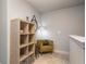 Cozy sitting area with an olive green armchair and decorative bookshelf near a stairwell at 366 Cherryhill Ln, Woodstock, GA 30188