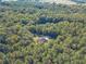 An aerial shot of a home situated in a large wooded lot with a detached garage at 946 Gaithers Rd, Mansfield, GA 30055